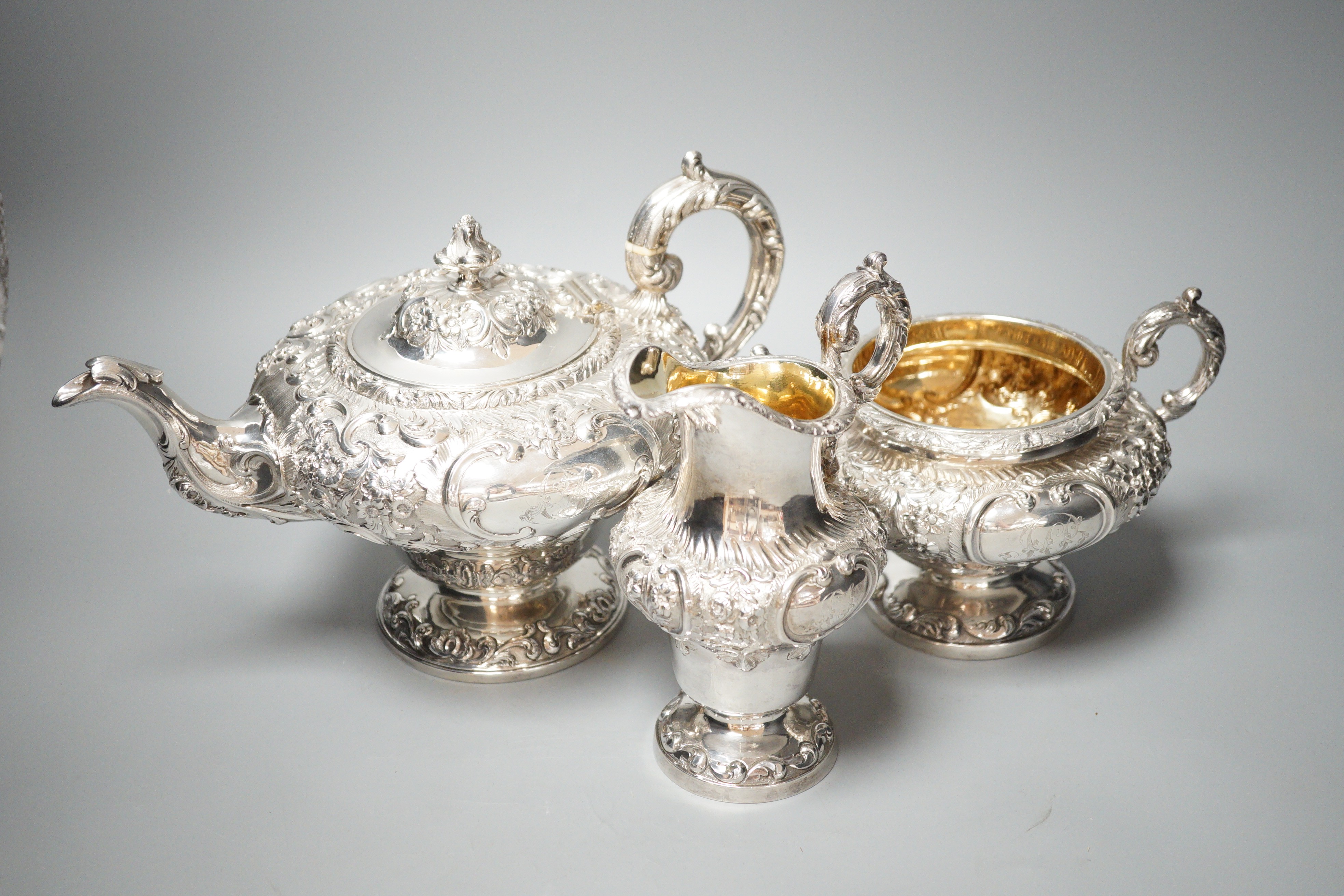 A matched Victorian embossed silver inverted pear shaped three piece tea set, teapot James Mackay, Edinburgh, 1839, cream & sugar, Charles Fox, London, 1838